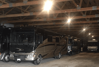 A group of recreational vehicles parked in a garage.